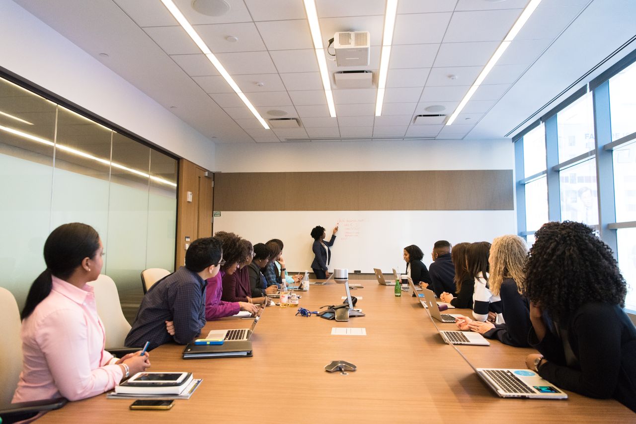 About Business meeting with diverse team discussing projects in a modern conference room.